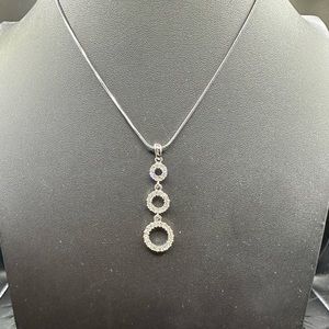 Triple circle clear crystals pendant on a silver chain.
